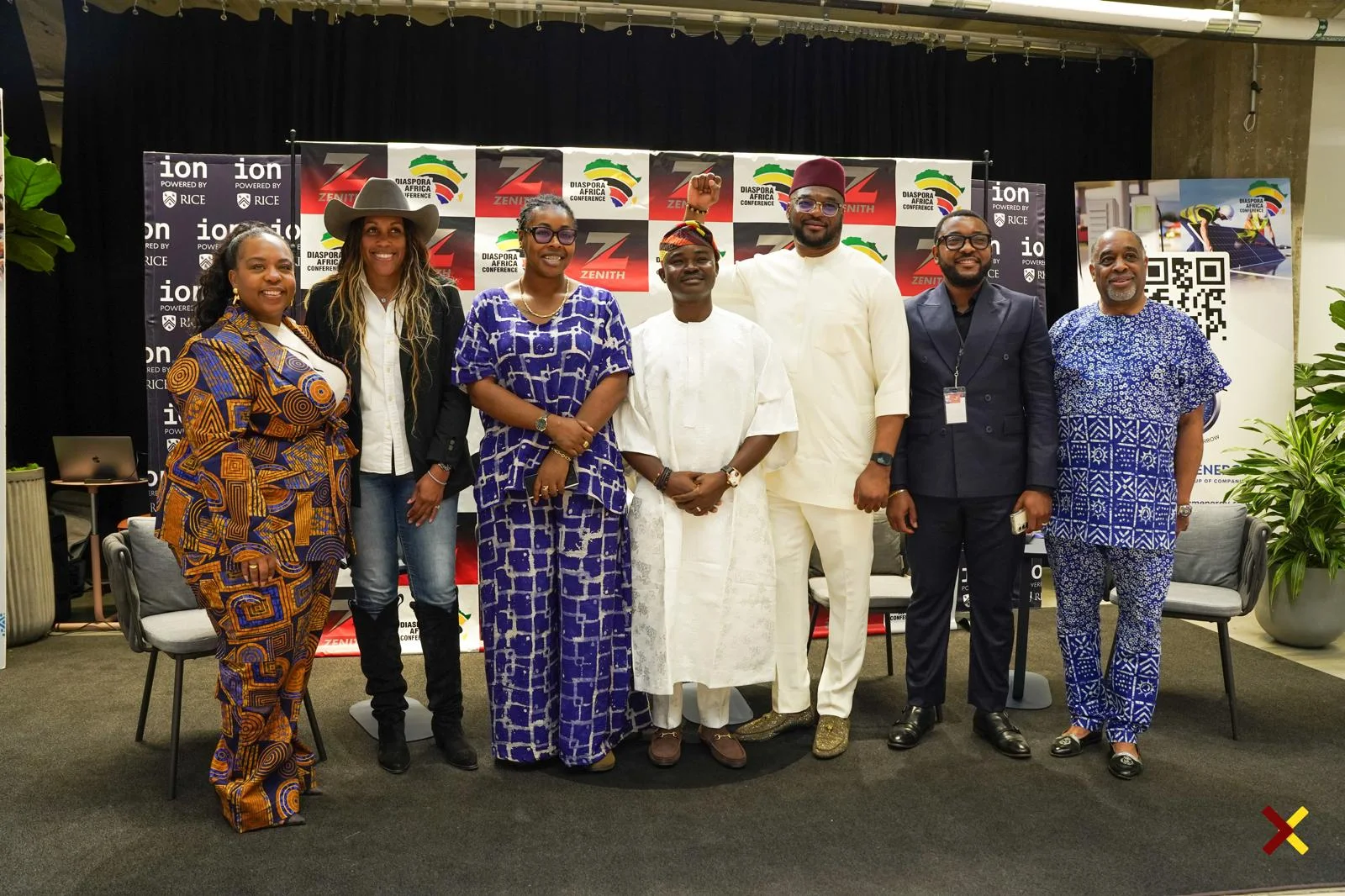 Dr. Alabi standing centrally with delegates on stage at the Diaspora Africa Conference in front of the ION, Rice University, and Zenith backdrops.
