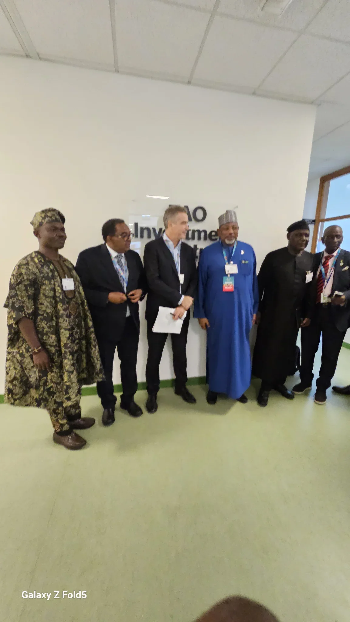 Dr. Alabi standing with Minister Abubakar Kyari and international policy executives in front of the official "FAO Investment Centre" sign in Rome.